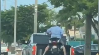 Truck Transports Motorcycle with Man On It