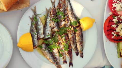 adding lemon to a fish dish