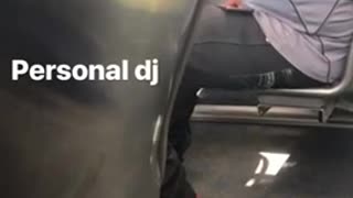 Personal dj man plays music out of his phone on bus