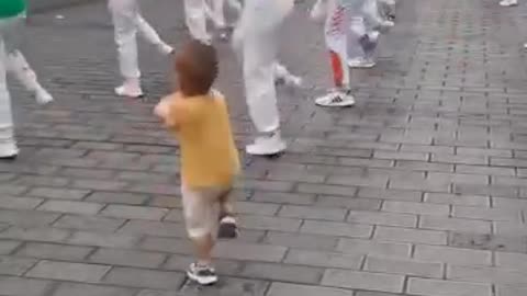 Kids cute dance along with dance troop by watching there steps he's dancing