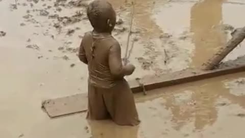 Funny child helps father in the rice field