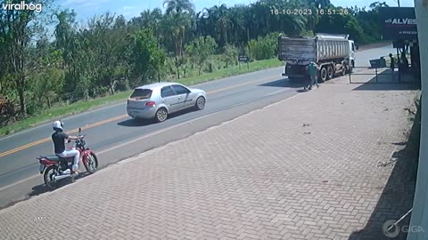 Motorcyclist Wheelies Into Oncoming Truck