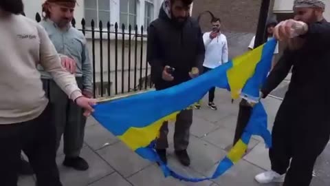 Swedish flag burned outside the Swedish embassy in London by Protesters