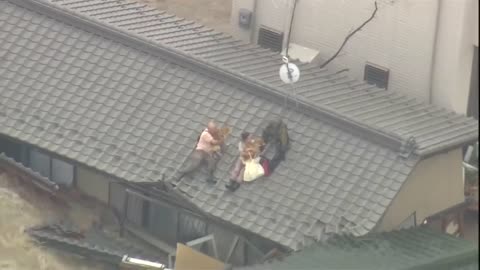 Japan floods Couple and their dogs rescued from rooftop after Joso City submerged under water