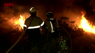 Raging wildfires in Catalonia reach houses