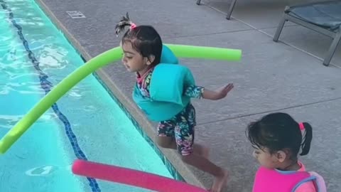 Siblings enjoying in pool area