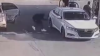 Thieves steal a guy's car while he pumps gas