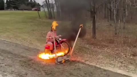 Idiot On Bike Jumps Through Fire
