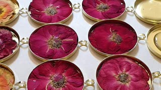 making 40 resin necklaces at the same time, with pressed miniature roses