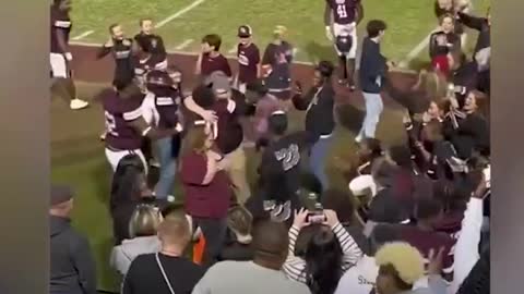 Watch this high school football team react to coach proposing to girlfriend