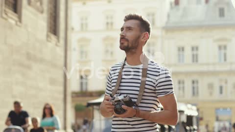 Handsome Man Taking Photos With A Camera In The Old Town