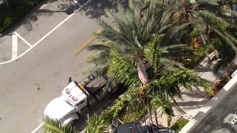 Crane lifts mini-tractor onto 4th Floor.