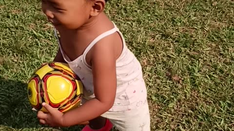 Baby playing football