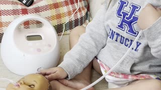Toddler Feeds Doll With Pump