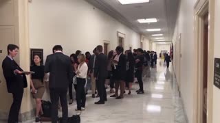 Long line of people outside the halls of Congress demanding Chris Wray be detained.