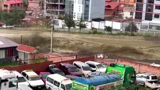 Raging river bursts banks in Bolivia after heavy rains