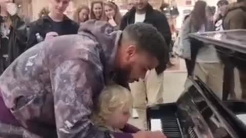 Curious little boy adorably kicks performer off his piano so he can try playing