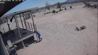 Kid Riding His Bike Gets Caught in Dust Devil