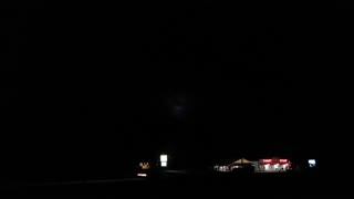 One cloud in the night sky with lightening.