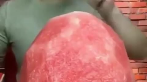 Asian eats watermelon