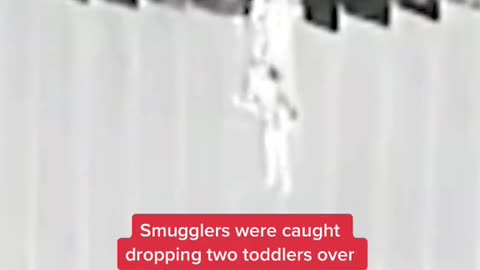 Smugglers were caught dropping two toddlers over the border wall