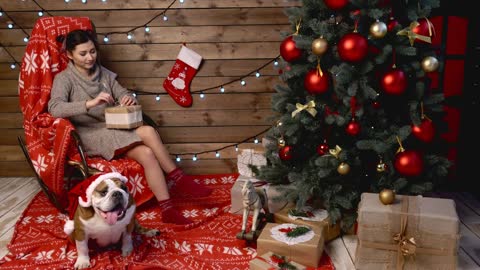 woman and her dog at xmas wrapping gifts