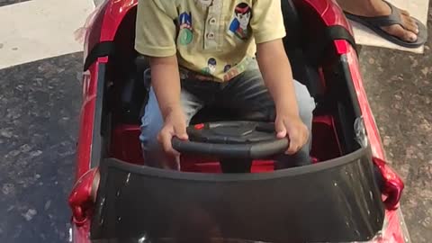 # small kid enjoing small car driving