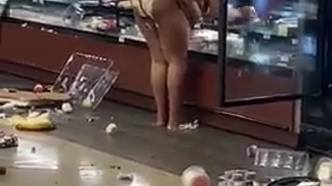 mentally ill woman destroys the entire food section of the store while employees watch on