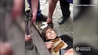 Donetsk police video shows injured woman rescued