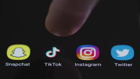 Close Up Shot of Finger Tapping TikTok On a Smartphone Screen