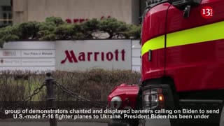 Emergency services and protesters at Biden's Warsaw hotel