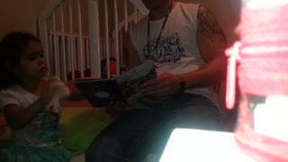 Daddy reads Cinderella with his daughter for bedtime story