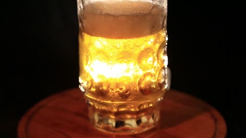 crystal glass for beer draught wheat video on a black background yellow beer