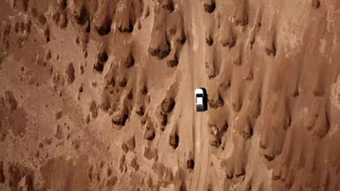 vehicle-traveling-across-the-desert land