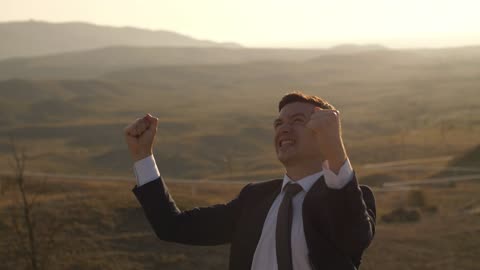 Entrepreneur who wears a suit celebrating