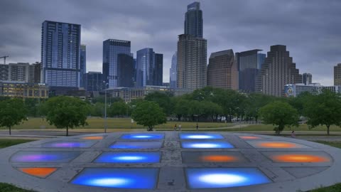Platform with lights in a park within a big city
