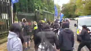 Someone from the Chinese consulate in Manchester knocks over pro-democracy signs