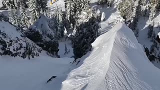 Skier Navigates Steep Cliff