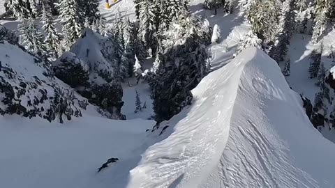 Skier Navigates Steep Cliff