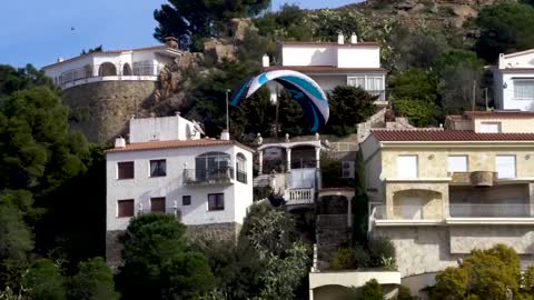 Group of Professional Athletes Paraglide Around Gorgeous Landscape of Costa Brava in Spain