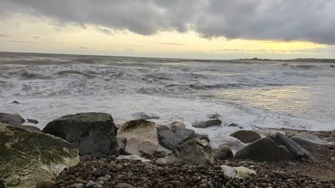 Kids, parents, waves, rocks and wind.