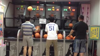 Man Shoots Hoops At The Arcade With Both Hands