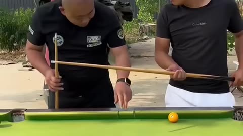 Two men playing billiard