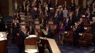 Democrats stand for a round of applause as Biden talks about funding the police