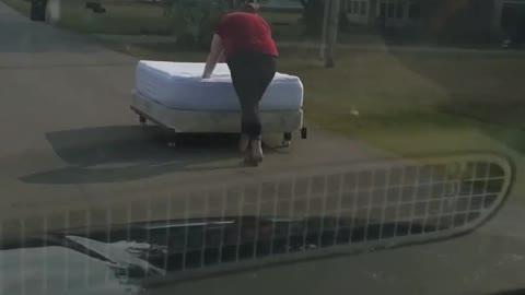 Girl Pushes Newly Bought Bed Down the Road