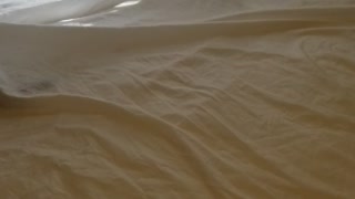 Putting sheets on the bed has challenges