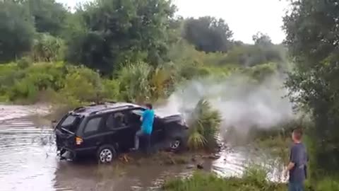 Stuntman in Training Jumps SUV Over a Creek