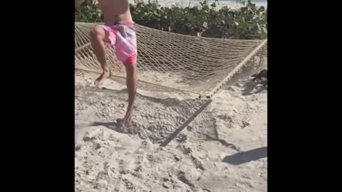 Beach hammock slomo man fall off