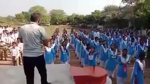 Morning exercise in Indian school with sports teacher and student