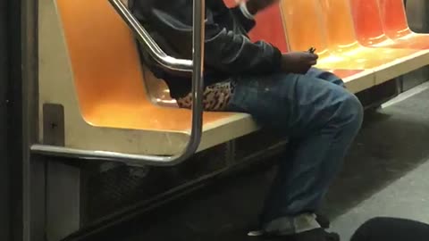 Two men smoke on subway train